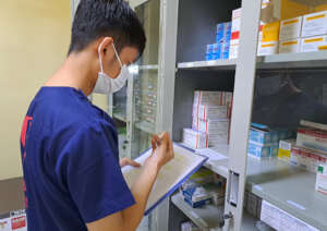 Pharmacist checking the inventory of medications