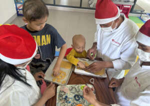 Cutting Christmas Cookies with Kitchen staff