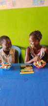 Girls having healthy fruit salad at the centre