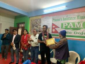 PAM Chairperson honouring Global Giving Donor