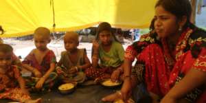 Children being served with food in a 2nd community