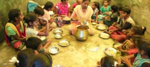 Children being served with food in a community
