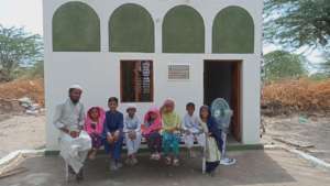 Family Sitting in Newly Built Bricked House