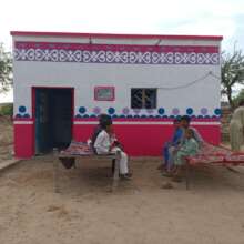 Happy children in front of their new home
