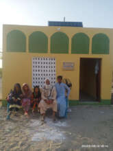 Happy family in front of their new house