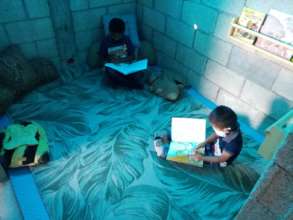 Children enjoying reading books in reading corner