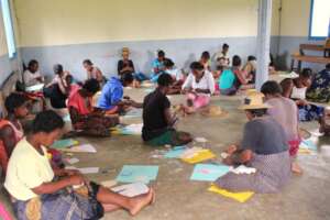 Women in a pad-making learning session