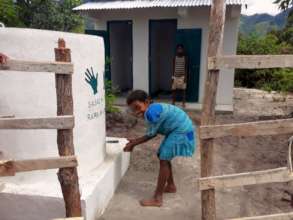 A student at Vatambe Primary School washing hands