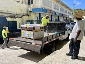 Volunteers deliver vinyl floorig for VICM