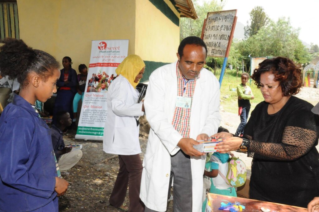 A partial view of a girl receiving edu materials