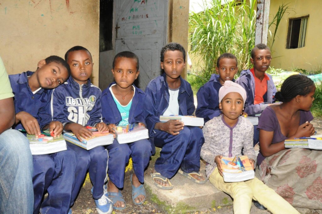 A partial view of a girl receiving edu materials