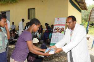 A partial view of  girl  receiving educ materials