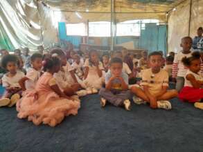 Partial picture of children   supported by MHO