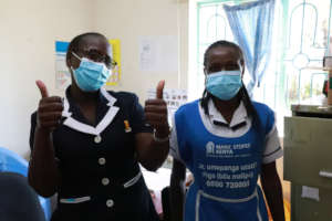 Thumbs up for the vaccine from health care staff