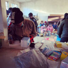 Kids sign in as they collect hygiene products