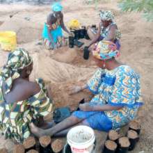 Women filling the tree sachets with the soil