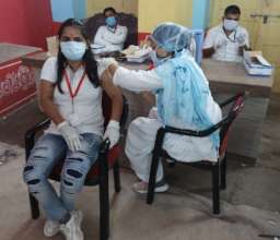 Community volunteer receiving Covid vaccine