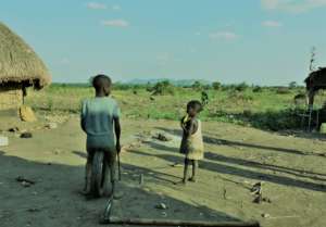 Two children play at their home compound