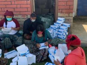Packaging masks in box for deliver to health posts