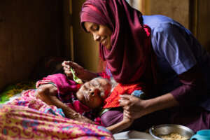 Asssistant feeding a patient