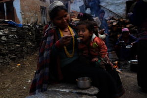 Feeding nutritious Food to a child in Karnali