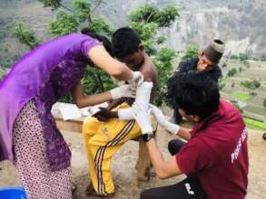 PHASE Nepal staff helping the boy to heal