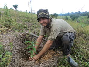 Chris planting a tree at Besitang