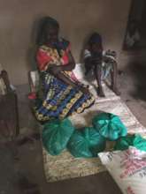 Community members receive monthly food supply.