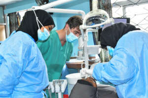 Patient being examined by doctors at Mega camp
