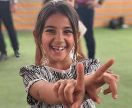 A girl at Hope Bus 3 just beams with joy