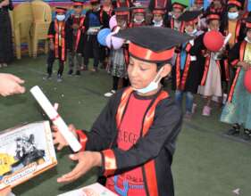 A proud boy graduates from Hope Bus 2