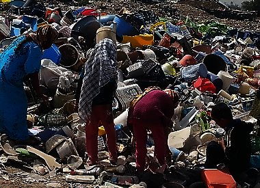 Some kids work collecting cans from the city dump