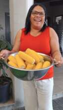Principal handing out lovely corn to our learners
