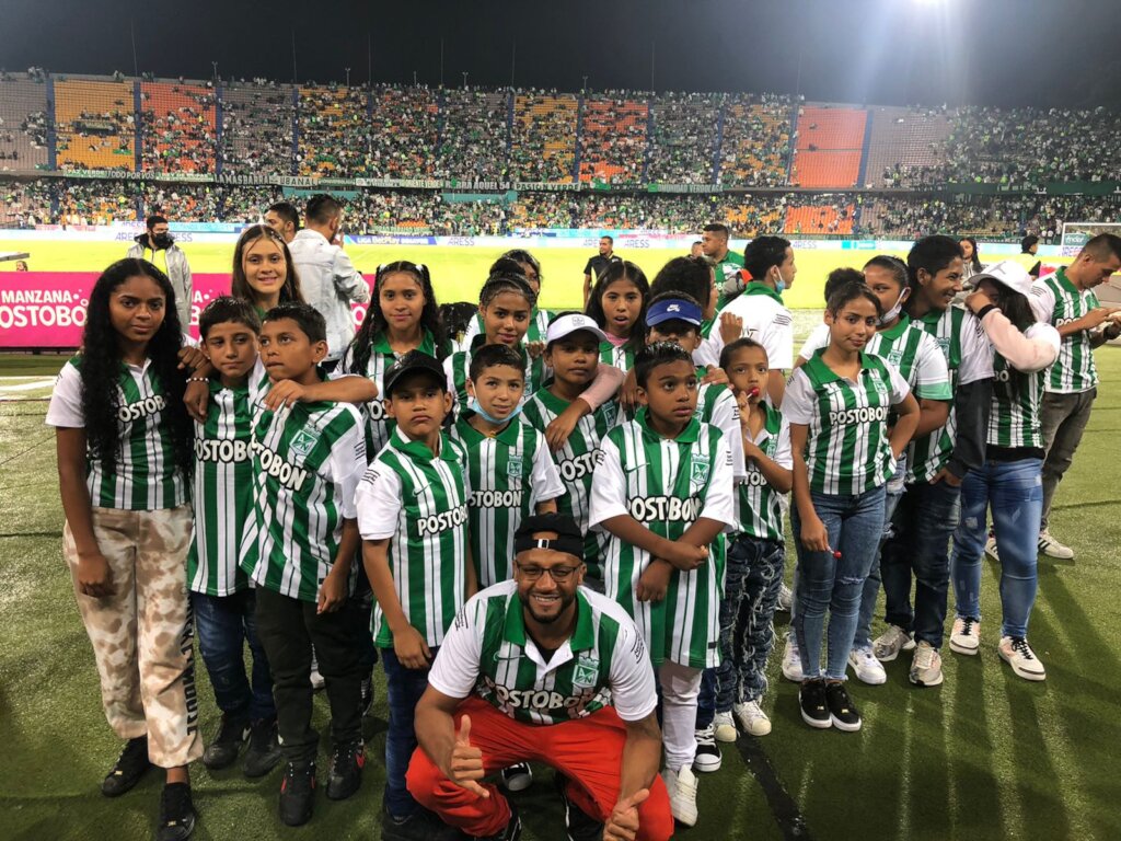 Enjoying a soccer match with jerseys and all