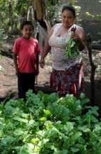 Woman and her son showing their radish crops