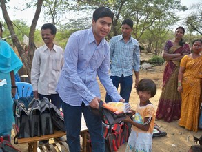 Girl Child receiving  Bag, Water Bottle etc.,
