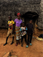 Eunice with her siblings in front of their home