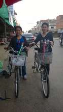 Ratana and her friend with their bikes.