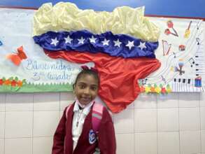 Student with welcome poster at the back