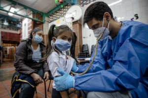 Doctors collecting blood samples of the students