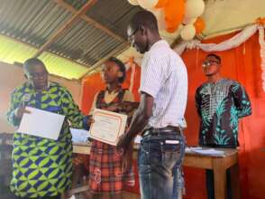 Priciailla  receiving her certificate of honor.