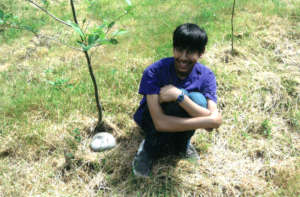 Levi Next to a Tree at the Caring Cabin
