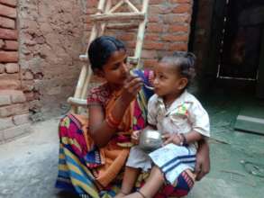 Mother feeding her son food