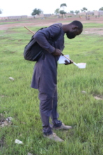 Issa Inspecting Water Sources for Mosquitos