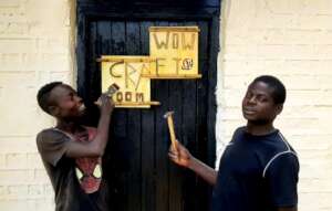 Ignatius and Hassan with Craft Room Sign