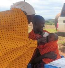 Local operator taking baby's temperature
