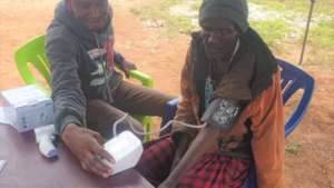 Male operator taking blood pressure of patient