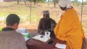 Local operator measuring blood pressure of patient