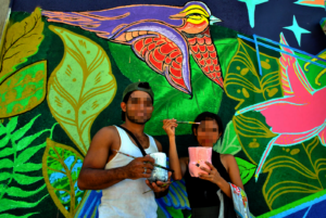 Teenagers collaborating in the mural