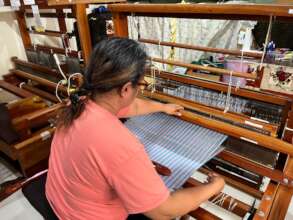 Trainee weaving a shawl